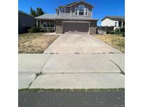 Two-story house with a brick front and attached garage at 2217 S Telluride Ct, Aurora, CO 80013