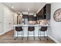 Modern kitchen with stainless steel appliances and an island with seating at 20 Wilcox St # 621, Castle Rock, CO 80104