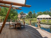 Deck overlooking a pond with seating for four at 5280 S University Blvd, Greenwood Village, CO 80121