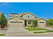 Two-story house with three car garage and landscaped yard at 14595 Vancouver Pl, Parker, CO 80134