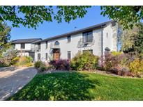 Two-story white brick home with landscaped lawn and driveway at 1490 Saint Andrews Dr, Broomfield, CO 80020