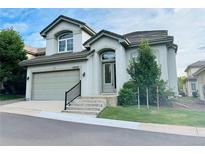 Two-story home with attached garage and landscaping at 12029 E Lake Cir, Greenwood Village, CO 80111