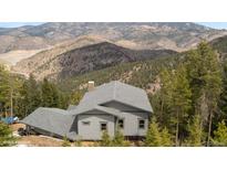House with mountain views and gray siding at 1810 Saddleback Dr, Evergreen, CO 80439