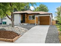 Modern craftsman style home with a carport and landscaped yard at 4643 S Cherokee St, Englewood, CO 80110