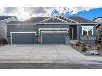 Two-story house with a three-car garage at 3825 Freestone Pt, Castle Rock, CO 80108