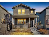 Charming two-story home with a covered front porch and inviting walkway at 4780 N Kalispell St, Denver, CO 80239