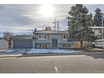 Updated ranch home with gray siding, new garage door, and landscaping at 6906 W Fremont Pl, Littleton, CO 80128