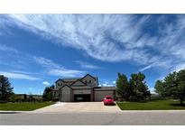 Two-story house with a three-car garage and landscaped yard at 7047 Lionshead Pkwy, Lone Tree, CO 80124