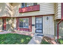 Townhouse exterior with brick facade and a well-maintained lawn at 436 S Carr St, Lakewood, CO 80226