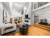 Spacious living room with high ceilings, fireplace, and hardwood floors at 255 S High St, Denver, CO 80209