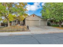 Brick house with double garage and landscaping at 11384 Oakland Dr, Commerce City, CO 80640
