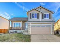 Two-story home with attached garage, front porch, and landscaped yard at 4453 S Fundy St, Centennial, CO 80015