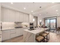 Modern kitchen with island, stainless steel appliances, and quartz countertops at 1901 Wazee St # 719, Denver, CO 80202