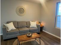 Cozy living room featuring a gray sofa, wood coffee table, and decorative accents at 756 Inca St, Denver, CO 80204