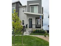 Modern two-story home with gray siding and a landscaped lawn at 12261 Karls Ln, Northglenn, CO 80241