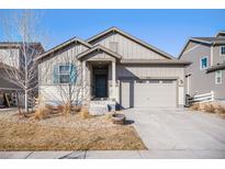 Charming two-story home with a welcoming front porch and attached two-car garage at 7285 S Titus Way, Aurora, CO 80016