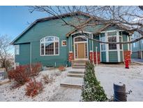 Charming two-story home with snow-covered landscaping and brick accents at 2855 Rock Creek Cir # 129, Superior, CO 80027