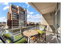 Urban balcony view with seating, showcasing city skyline at 1610 Little Raven St # 407, Denver, CO 80202