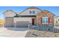 Two-story house with stone and siding exterior, double garage at 4411 Hickory Oaks St, Castle Rock, CO 80104
