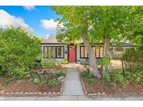 Front view of charming house with red door and landscaping at 2492 N Lamar St, Edgewater, CO 80214