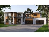 Two-story modern home with wood and white exterior, three-car garage, and landscaped lawn at 5266 Flora Way, Arvada, CO 80004