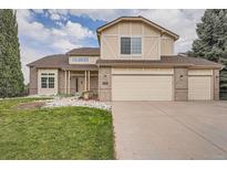 Two-story house with two-car garage and landscaping at 9357 Lark Sparrow Dr, Highlands Ranch, CO 80126