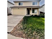 Two-story home with attached garage and green lawn at 21030 E 39Th Ave, Denver, CO 80249