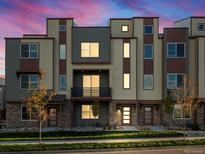 Contemporary three-story townhome featuring a balcony and neutral color palette at 13957 Del Corso Way, Broomfield, CO 80020