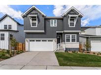 Two story craftsman style home with gray siding and white trim at 16451 W 93Rd Ave, Arvada, CO 80007