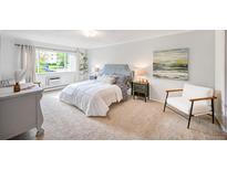 Bedroom with window, chair, and bedside tables at 660 S Alton Way # 7A, Denver, CO 80247