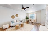 Bright and airy living room with hardwood floors and modern decor at 477 Interlocken Blvd # 103, Broomfield, CO 80021