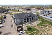 Aerial view of a modern apartment building with ample parking and city views at 875 E 78Th Ave # 53, Denver, CO 80229