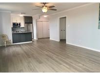 Spacious living room with hardwood floors and kitchen access at 320 S Ames St # 5, Lakewood, CO 80226