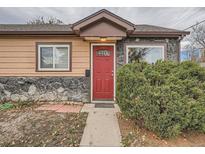 Charming ranch home with stone accents and a red front door at 1297 Worchester St, Aurora, CO 80011