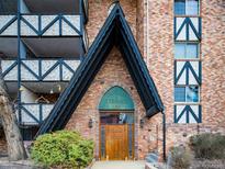 Brick building exterior with a wooden door and unique architectural details at 1350 Josephine St # 403, Denver, CO 80206