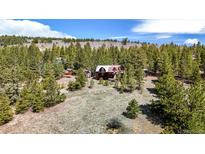 Aerial view of a rustic cabin nestled in a wooded mountain setting at 131 Russel Gulch Rd, Central City, CO 80403