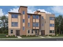 Three-story modern townhome with light brown and beige exterior at 14245 Currant St, Broomfield, CO 80020