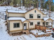 Two-story home with snowy yard and mountain views at 26446 Grateful Way, Kittredge, CO 80457