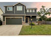 Two-story home with a two-car garage and well-manicured lawn at 11202 Dover St, Firestone, CO 80504