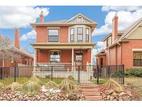 Charming brick two-story home with a classic porch and well-maintained landscaping at 3360 W 31St Ave, Denver, CO 80211