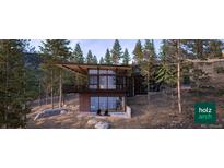 Modern home nestled in a wooded hillside setting at 7 Canyon Pines Dr, Arvada, CO 80403