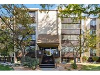 Condo building exterior with landscaping and steps leading to the entrance at 3460 S Poplar St # 307, Denver, CO 80224