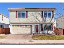 Two-story house with attached garage and brick driveway at 20000 Mitchell Pl # 71, Denver, CO 80249