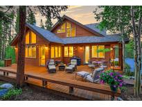 Lovely home exterior with deck and landscaping at dusk at 120 Windwood Cir, Breckenridge, CO 80424