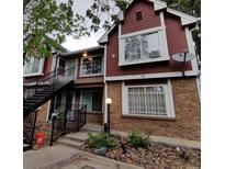 Two-story red and brown condo building with stairs leading to the second floor at 71 S Sable Blvd # B16, Aurora, CO 80012