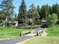 House exterior showing a large home nestled in a wooded area with a bridge leading to the property at 7948 S Turkey Creek Rd, Morrison, CO 80465