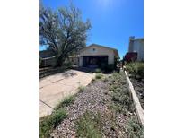Attached garage with driveway and landscaping at 18064 E Ford Pl, Aurora, CO 80017