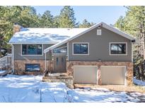 Two-story house with double garage and snowy landscaping at 746 Bow Mountain Rd, Boulder, CO 80304
