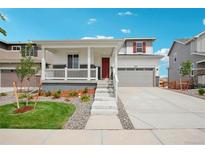 Two-story home with attached garage and landscaping at 3292 N Highlands Creek Pkwy, Aurora, CO 80019