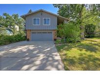 Two-story home with gray siding, a two-car garage and a well-maintained lawn at 6034 S Niagara Ct, Centennial, CO 80111